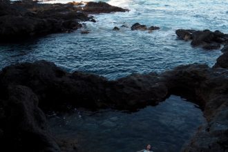 Thoughts I Had in Tenerife - Elle floats in a volcanic rock pool