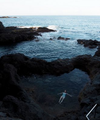 Thoughts I Had in Tenerife - Elle floats in a volcanic rock pool