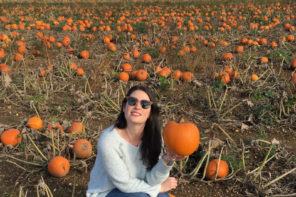 Elle Croft posing with pumpkin in field: Pumpkin Picking in Kent