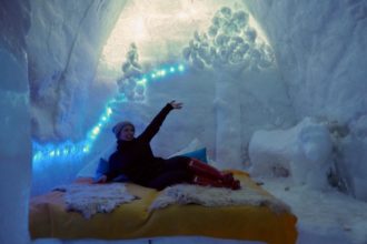 Elle Croft posing in Balea Lake Ice Hotel, Romania - What is Sleeping in an Ice Hotel Really Like?