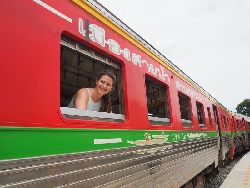 Elle posing in a train at Ban Laem Railway Station, Thailand