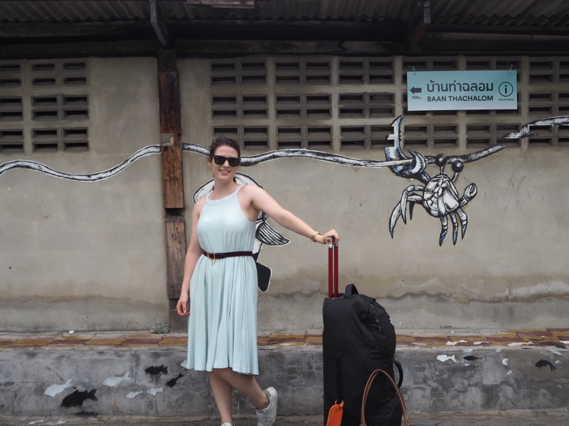 Elle walking with her luggage to Ban Laem Railway Station, Thailand