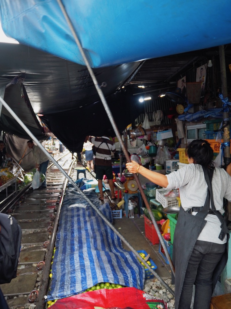 Market awnings being pulled down at Rom Hoops Market, Thailand