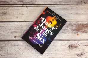 The book 'Daisy Jones and the Six' lying on a wooden surface