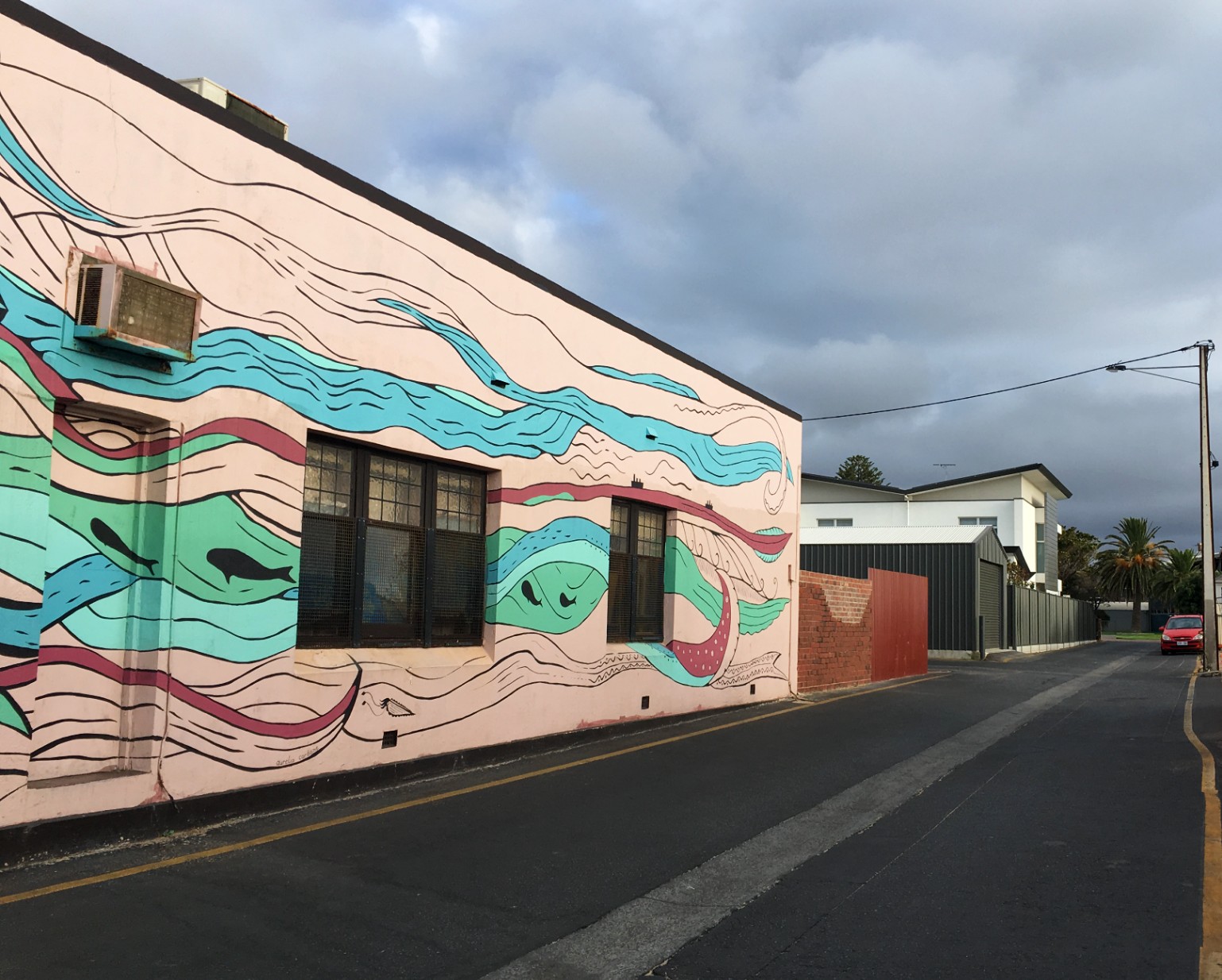 Colourful mural on building in alleyway