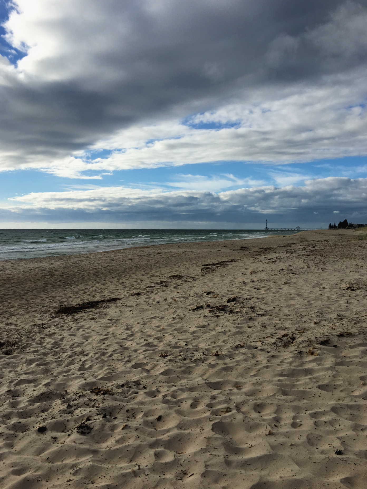 Sandy beach with partly cloudy skies